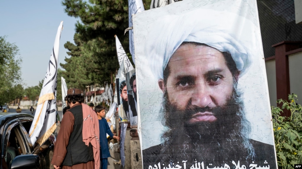 Poster of Taliban spiritual leader Haibatullah Akhundzada along a road in Kabul.