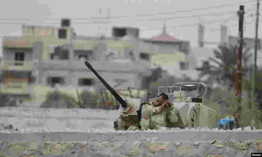 An Egyptian soldier takes a nap on the border between Egypt and the southern Gaza Strip. (Reuters/Ibraheem Abu Mustafa)