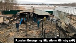 Emergency personnel work at the site of the fire in the village of Nesterovo outside Moscow on January 7.