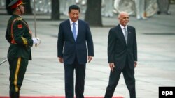 Afghan President Ashraf Ghani (right) and Chinese President Xi Jinping (center) review a guard of honor during a welcoming ceremony outside the Great Hall of the People in Beijing, China, on October 28. 