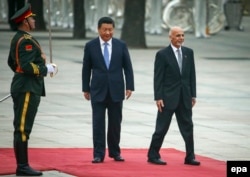 Ashraf Ghani (right) inspects a guard of honor with Chinese President Xi Jinping during the Afghan leader's trip to China shortly after he became president in 2014.