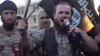 Ethnic Albanian Kosovar Lavdrim Muhaxheri (holding microphone) appears in an IS video calling on Albanian Muslims to join militants fighting against Syrian President Bashar al-Assad. 