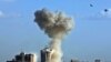 Smoke rises into the sky following an explosion in the area near Palestine Hotel in central Baghdad on June 25, one of at least three deadly explosions.