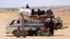 Syrians who fled the Islamic State (IS) group stronghold of Raqqa ride with their belongings on a truck in an area near the village of Balaban, south of Jarablus, on June 8.