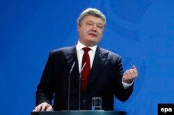 Ukrainian President Petro Poroshenko speaks during his joint press statement with German Chancellor Anglea Merkel at the chancellery in Berlin on January 30.
