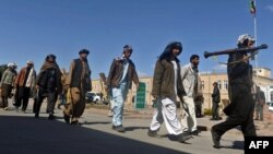 Taliban fighters walked with their weapons as they joined government forces during a ceremony in Herat province in March.