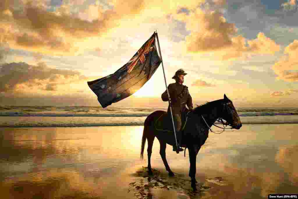 Chris Kennedy and his horse Chaos pose for photos on Currumbin Beach ahead of Australian and New Zealand Army Corps (ANZAC) Day on the Gold Coast of Australia on April 24. Anzac Day, held annually on April 25, commemorates the people who lost their lives or served in wars and conflicts. (epa-EFE/Dave Hunt)