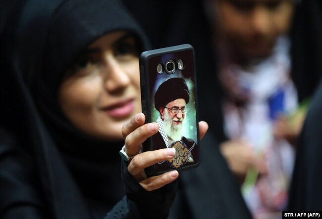 An Iranian woman shows off her phone cover depicting Supreme Leader Ayatollah Ali Khamenei in Tehran. Many warn that the Internet censorship under consideration could widen the gap between Iranians and the clerical establishment.
