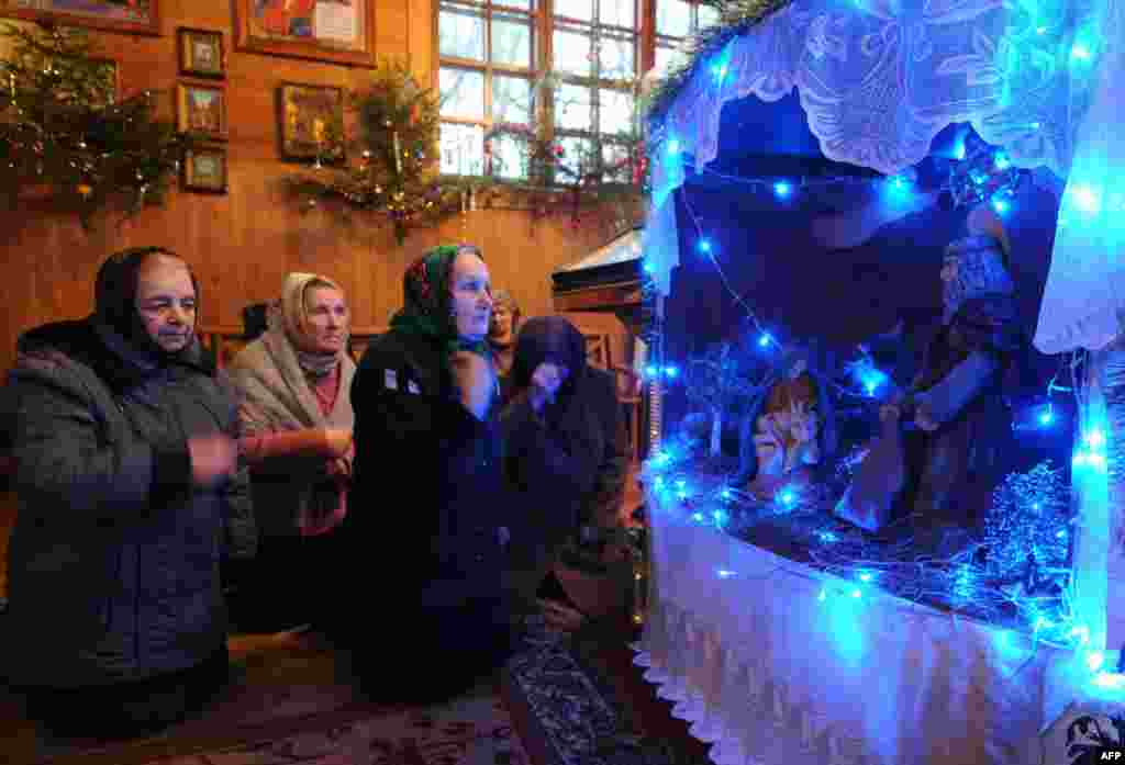 In Belarus, people pray in a church in the village of Plisa on January 6, 2014.