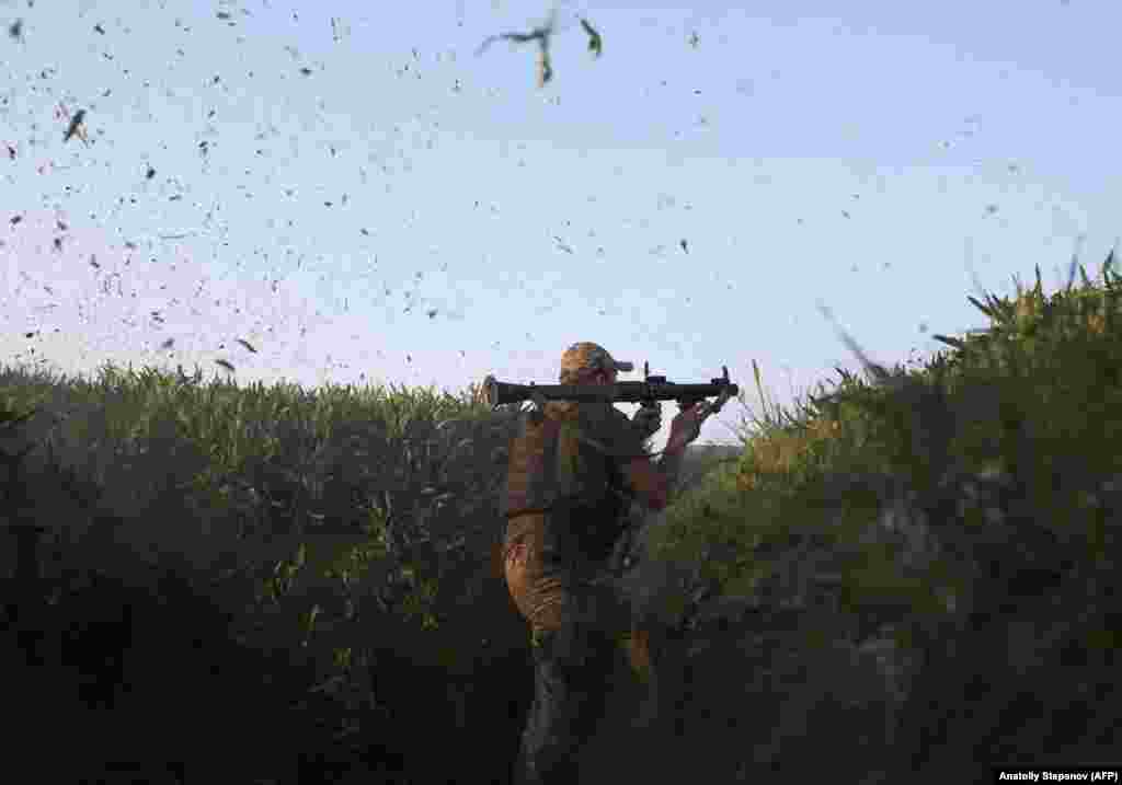 A Ukrainian serviceman fires a grenade launcher during combat with Russia-backed separatists near Gorlivka in the eastern Donetsk region on May 23. (AFP/Anatolii Stepanov)