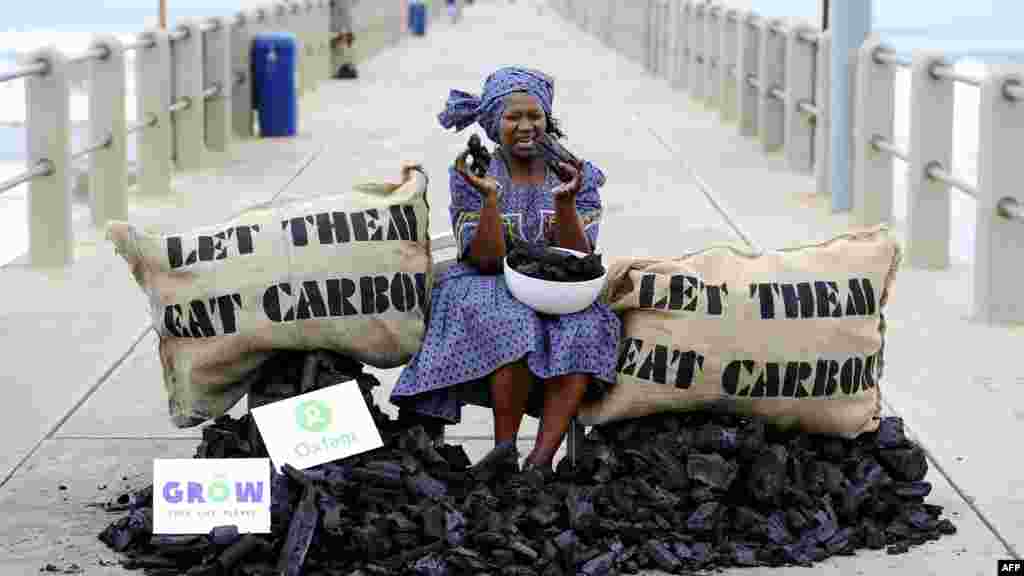 An activist from the British charity Oxfam stages a protest during UN climate change talks in Durban, South Africa, on December 9. (Photo for AFP by Stephane De Sakutin)