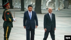 File photo of Afghanistan's President Ashraf Ghani (R) and Chinese President Xi Jinping.