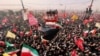 Mourners gather along the route of the convoy carrying the coffins of Iran's Supreme Leader Ayatollah Ali Khamenei and members of his family during a funeral procession in Qom on July 7.
