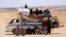 Syrians who fled the Islamic State (IS) group stronghold of Raqqa ride with their belongings on a truck in an area near the village of Balaban, south of Jarablus, on June 8.