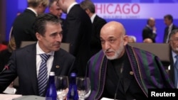 NATO Secretary-General Anders Fogh Rasmussen (left) and Afghan President Hamid Karzai