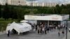 People wait in line at a vaccination center in a park in Moscow's outskirts on July 1.