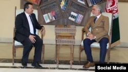 The head of Afghanistan's High Council for National Reconciliation, Abdullah Abdullah (right), meets with Saimumin Yatimov, the head of Tajikistan's State Committee for National Security, in Kabul.