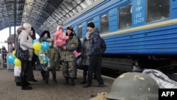 A file photo shows Ukrainian servicemen with relatives on a railway platform at a station in the western Ukrainian city of Lviv in January.