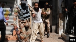 File photo of Pakistani rangers arresting a suspected in Karachi (March 20, 2015).