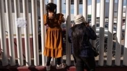 Asylum seekers wait for news on immigration appointments at the El Chaparral crossing port in Mexico on January 21.