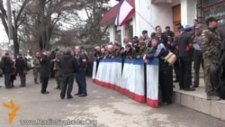 Nasıl edi: Rusiye tarafdarı askerler barışıq içün çıqqan qadınlarnı pek qaba şekilde sıqıştırıp çıqardılar (video)