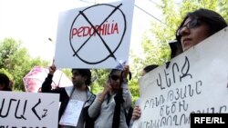 Armenia -- Young activists protest outside a Yerevan court during the trial of a school teacher accused of child sex abuse, 19May2010.
