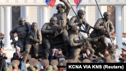 North Korean leader Kim Jong Un greets Russian officials earlier this year at a memorial in Pyongyang honoring North Korean soldiers who fought in Russia.