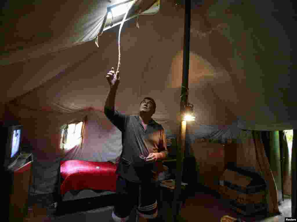 Grigory Dzasokhov stands in a tent, where he lives with his wife, as his house was destroyed during Georgia's war with Russia over South Ossetia, in Tskhinvali, July 22. Photo by Kazbek Basayev for Reuters