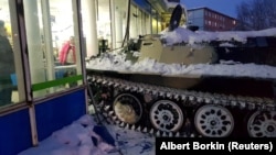 The driver of this armored personnel carrier smashed through a storefront and stole a bottle of wine.