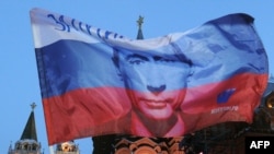 A Russian flag features the likeness of President Vladimir Putin in Moscow.