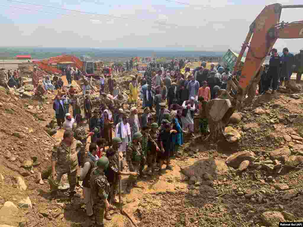 Soldiers and locals search for the victims of a mudslide in Parwan Province.