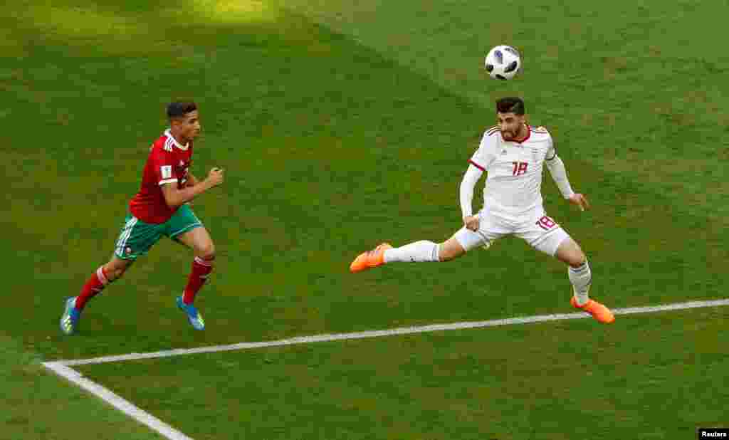 Soccer Football - World Cup - Group B - Morocco vs Iran - Saint Petersburg Stadium, Saint Petersburg, Russia - June 15, 2018 Iran's Alireza Jahanbakhsh in action with Morocco's Achraf Hakimi REUTERS/Lee Smith