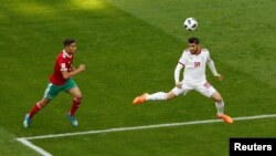 Soccer Football - World Cup - Group B - Morocco vs Iran - Saint Petersburg Stadium, Saint Petersburg, Russia - June 15, 2018 Iran's Alireza Jahanbakhsh in action with Morocco's Achraf Hakimi REUTERS/Lee Smith