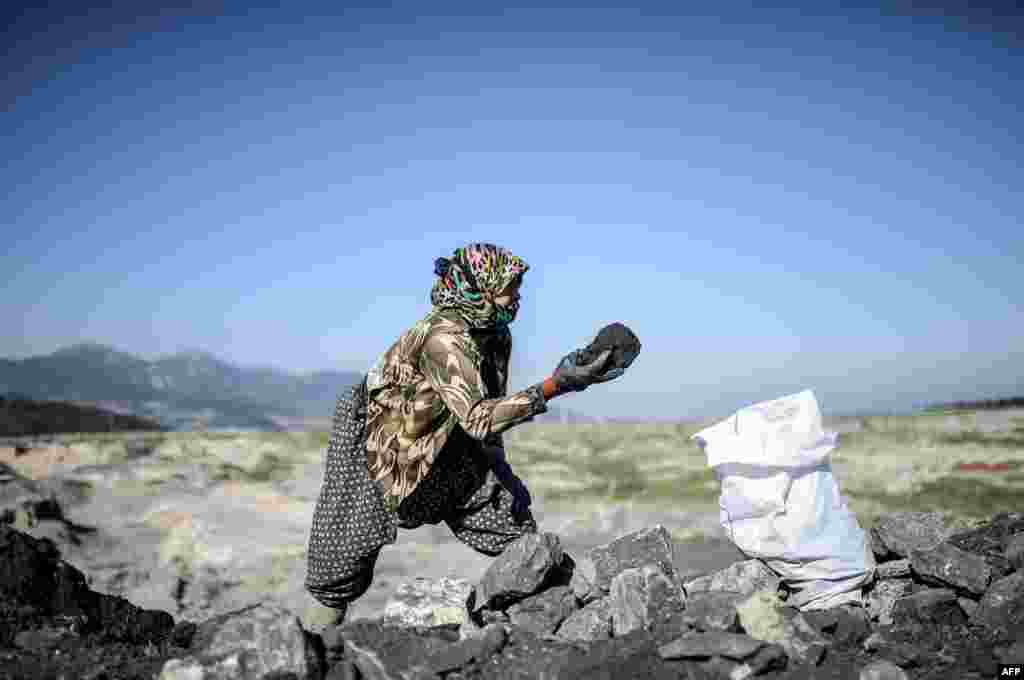 A villager collects coal outside the Soma mine in Manisa, Turkey. People gathered for the anniversary of the death of 301 workers after an explosion on May 13, 2014. (AFP/Bulent Kilic)