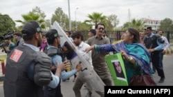 FILE: Pakistani police try to stop journalists during a rally to mark World Press Freedom Day in Islamabad on May 3.