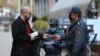 Armenia -- Police officers check documents of a man in Yerevan as part of a coronavirus lockdown imposed by the government, March 25, 2020.