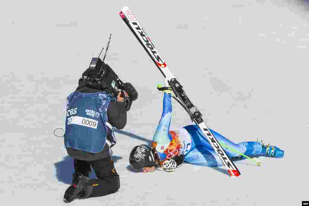 Slovenia&#39;s Tina Maze kisses the snow in the finish area after her run in the women&#39;s downhill race at the Rosa Khutor Alpine Center. Maze won the gold along with Dominique Gisin of Switzerland.