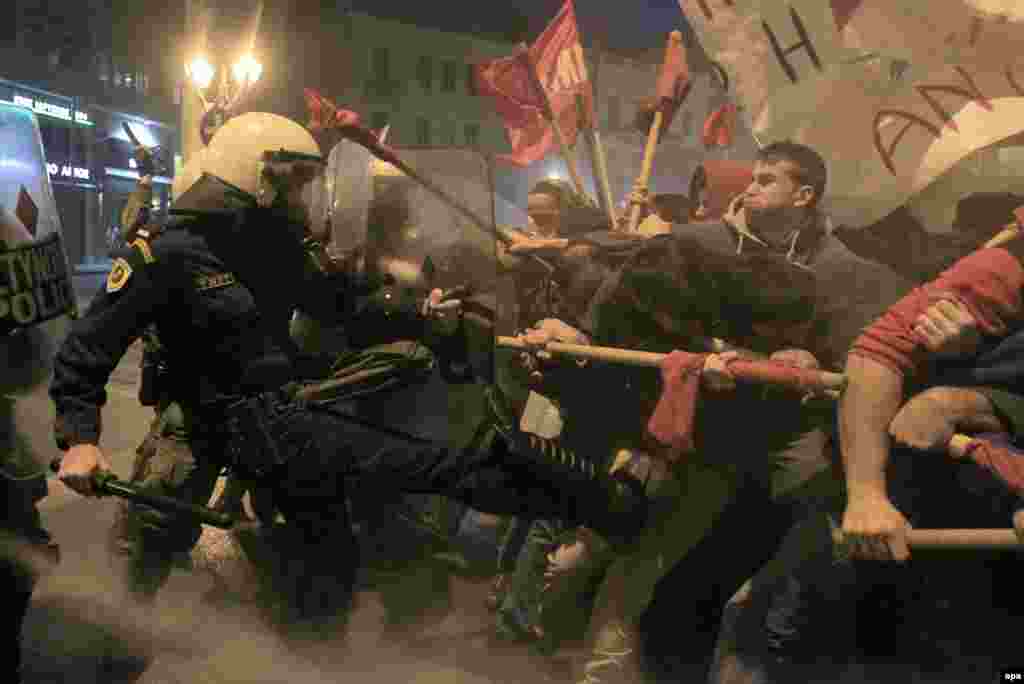 Protesters clash with Greek riot police during a protest against the Eurogroup and Ecofin meetings taking place in Athens. (epa/Orestis Panagiotou)