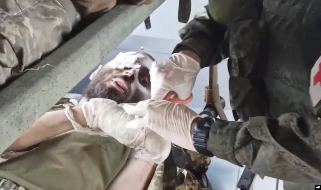 A video released by the Russian Defense Ministry shows a wounded Ukrainian soldier receiving treatment in a bus after being evacuated from the Azovstal steel plant.