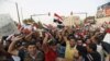 People shout slogans during a demonstration against corruption and poor services at Tahrir Square in central Baghdad on August 7.