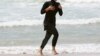 Australia -- Twenty-year-old trainee volunteer surf life saver Mecca Laalaa runs along North Cronulla Beach in Sydney during her Bronze medallion competency test January 13, 2007.