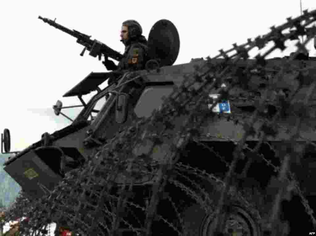 A German soldier of the NATO-led forces in Bosnia secures a checkpoint near the town of Pale in 2004 - NATO troops made a number of attempts over the years to snare Karadzic in the vicinity of his former stronghold of Pale, Bosnia. But it was in Belgrade that he was eventually caught, prompting speculation that Serbian leaders at last mustered the political resolve to ensure his capture.