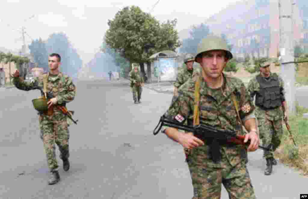 patrol the streets of Gori, central Georgia, during the armed conflict with South Ossetian separatist troops on August 9, 2008. Georgian President Mikheil Saakashvili declared a "state of war" on August 9 as his troops battled it out with Russian forces over the breakaway province of South Ossetia. Russian warplanes bombed the Georgian city of Gori, killing civilians, Georgia's Public TV reported. AFP PHOTO / VANO SHLAMOV 