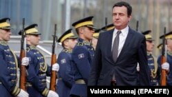 Newly elected Prime Minister Albin Kurti reviews Kosovo's honor guard during the handover ceremony in Pristina on February 4.