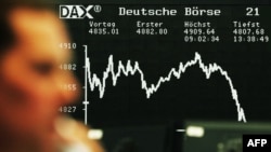 A German stock trader makes a call as stocks tumble