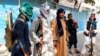 Taliban fighters stand guard in the city of Kunduz in northern Afghanistan on August 9.