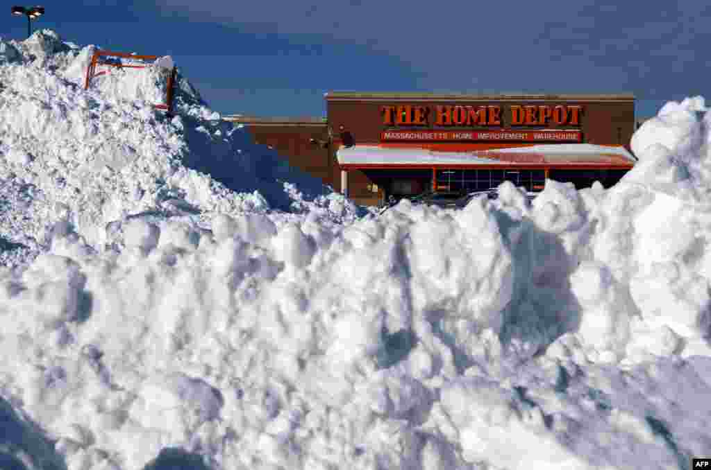 Snow is piled high in front of a Home Depot store in Boston, Massachusetts. 