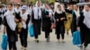 Afghan schoolgirls walk home after attending classes in the Fayzabad district of Badakhshan province. Under Taliban leadership, girls over the age of 12 are now forbidden from attending classes. (file photo)