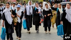 Afghan schoolgirls walk home after attending classes in the Fayzabad district of Badakhshan province. Under Taliban leadership, girls over the age of 12 are now forbidden from attending classes. (file photo)