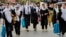Afghan schoolgirls walk home after attending classes in the Fayzabad district of Badakhshan province. Under Taliban leadership, girls over the age of 12 are now forbidden from attending classes. (file photo)